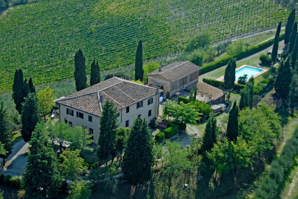 an aerial view of a house with trees and a pool at Podere Remignoli in San Gimignano