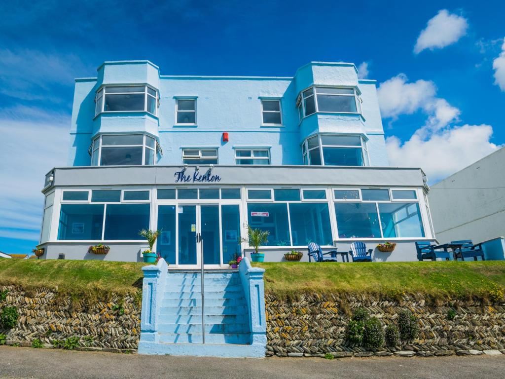 a blue and white building with chairs in front of it at Kenton in Newquay