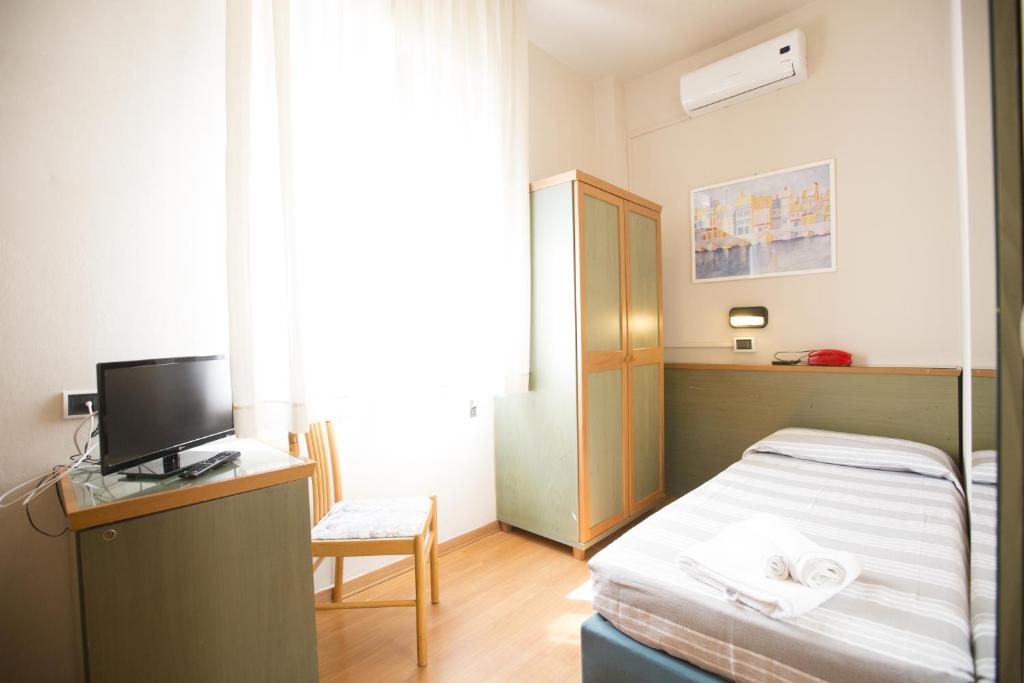 Postel nebo postele na pokoji v ubytování Hotel Impero