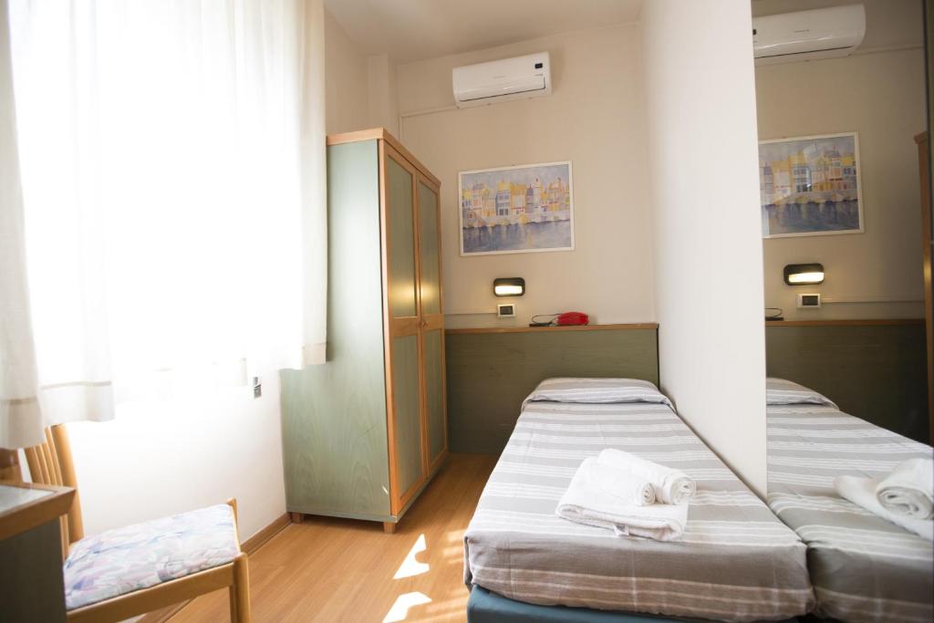 Postel nebo postele na pokoji v ubytování Hotel Impero