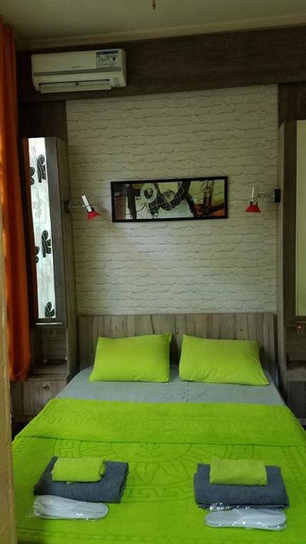 Postel nebo postele na pokoji v ubytování Nona's Guest House