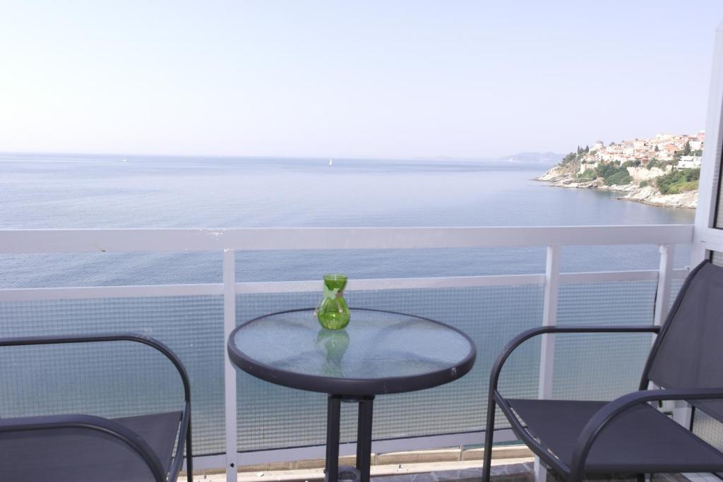 a glass vase sitting on a table on a balcony at Traveler Homes 2 in Kavála