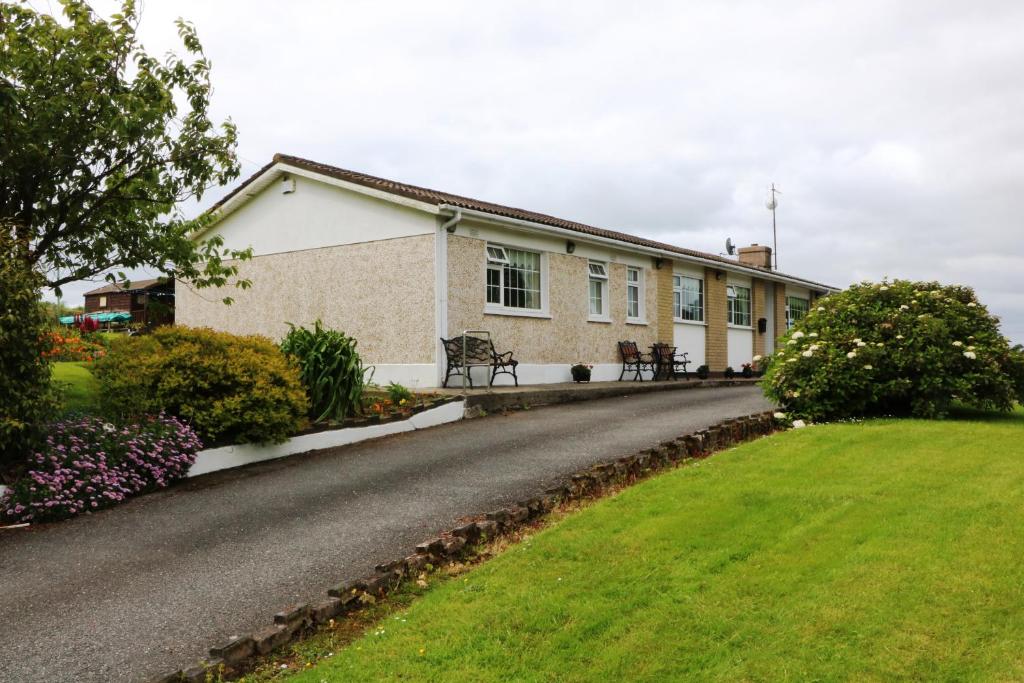 uma casa com um relvado verde em frente em Comeragh View em Dungarvan