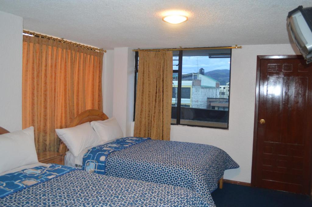 Postel nebo postele na pokoji v ubytování Hostal Alborada Riobamba