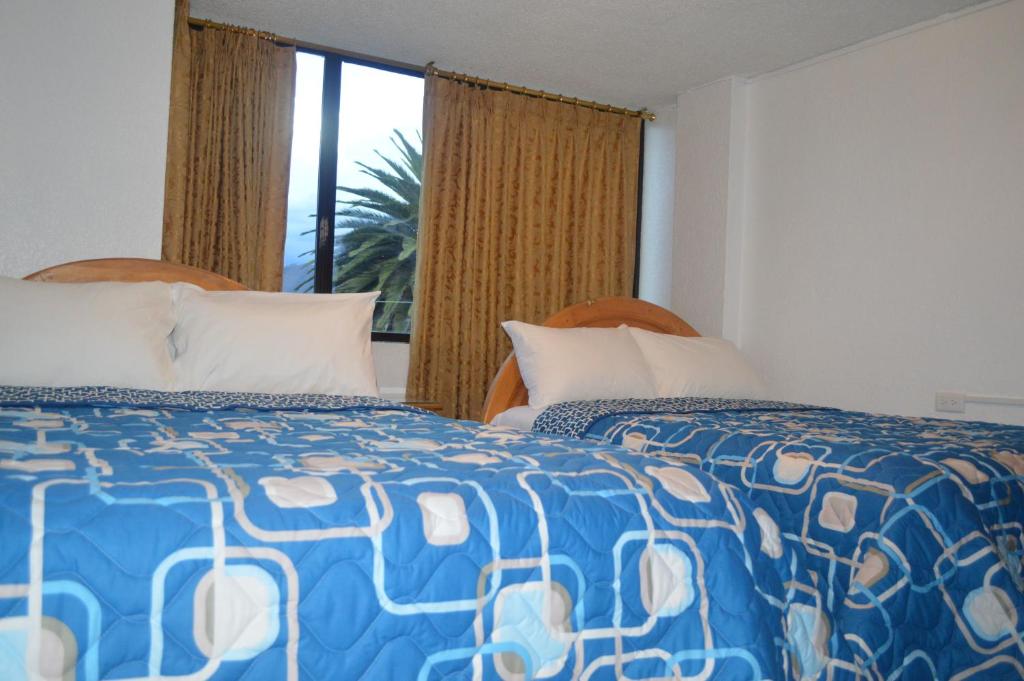 Postel nebo postele na pokoji v ubytování Hostal Alborada Riobamba