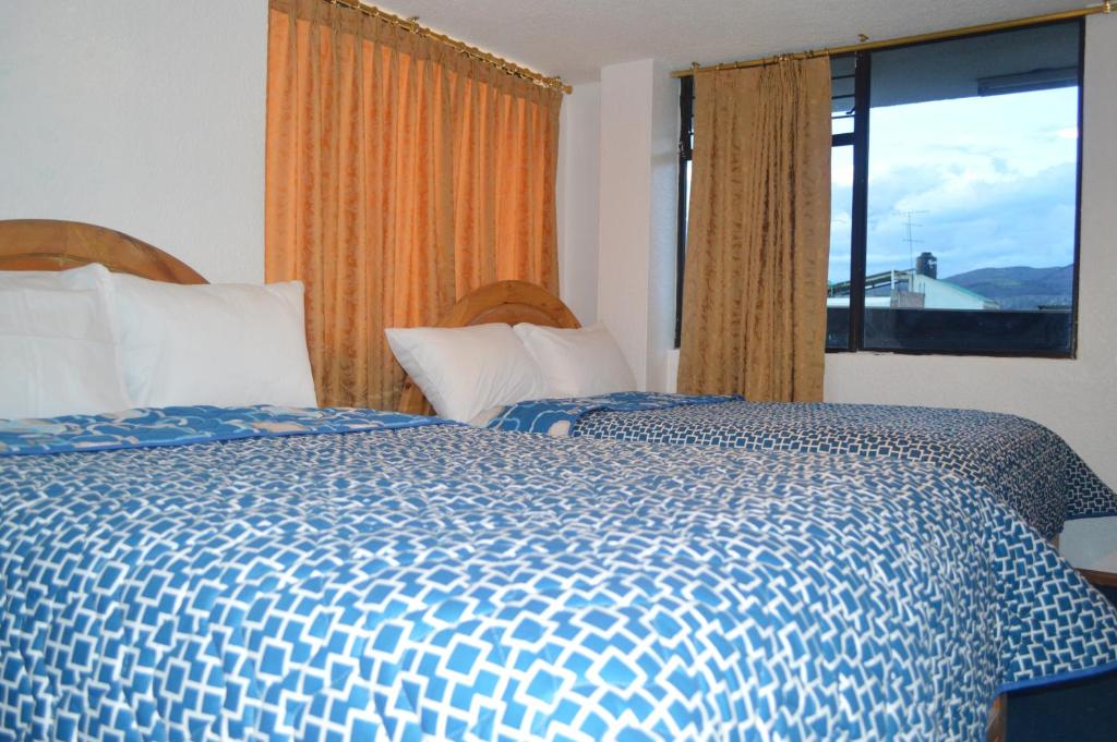 Postel nebo postele na pokoji v ubytování Hostal Alborada Riobamba