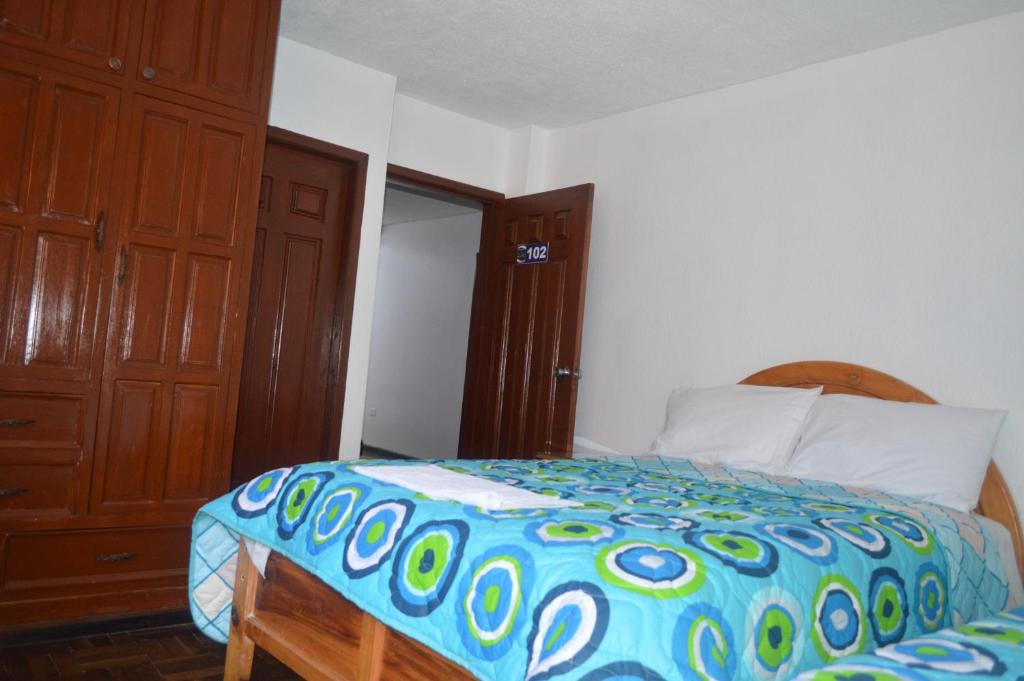 Postel nebo postele na pokoji v ubytování Hostal Alborada Riobamba