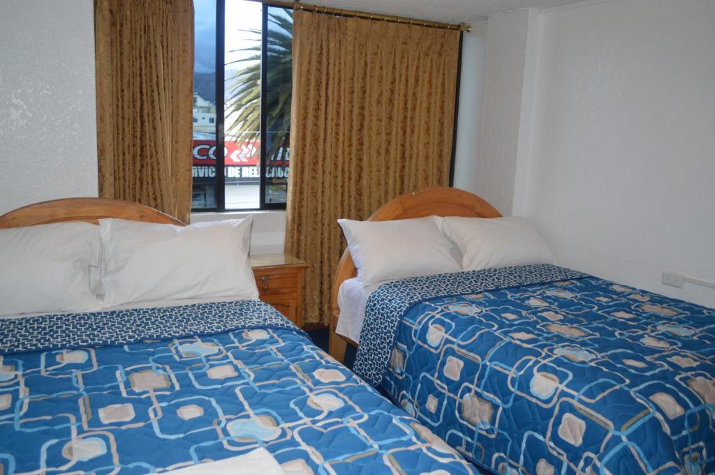 Postel nebo postele na pokoji v ubytování Hostal Alborada Riobamba