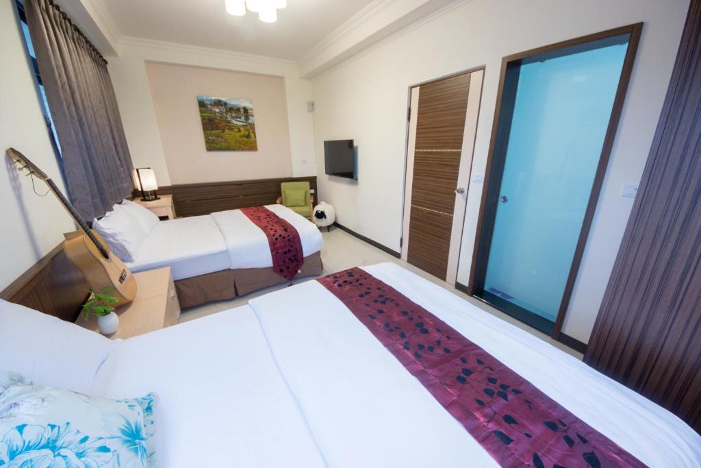 Postel nebo postele na pokoji v ubytování Guitar Charm B&B