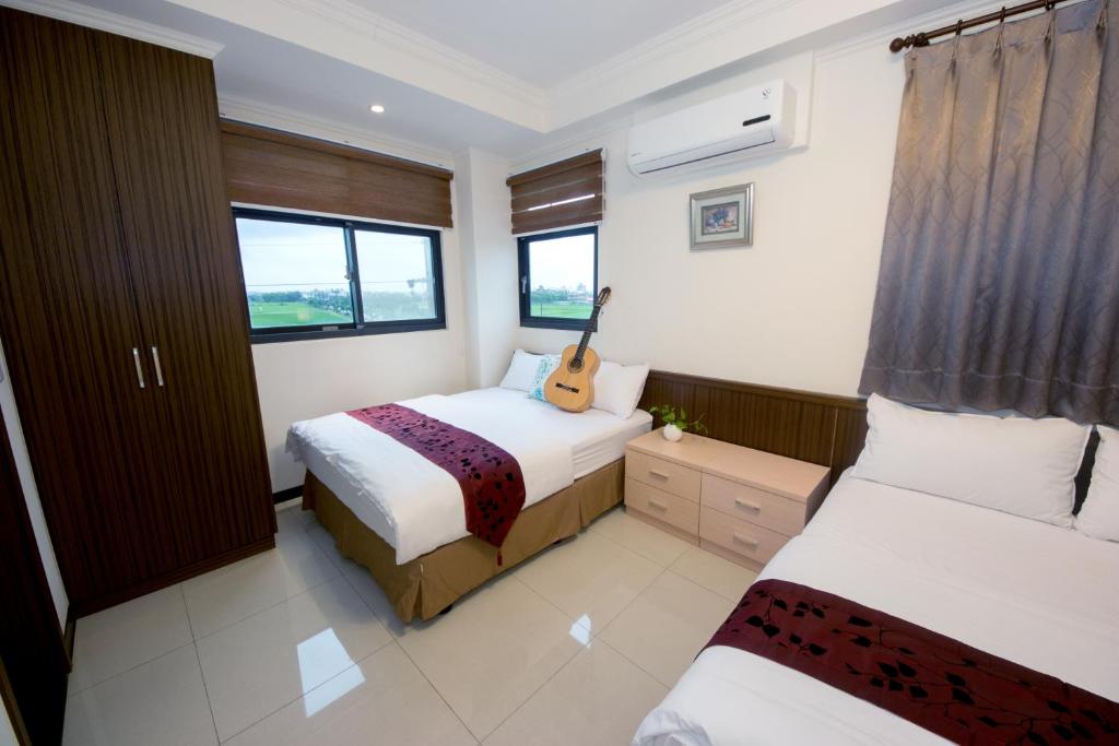 Postel nebo postele na pokoji v ubytování Guitar Charm B&B