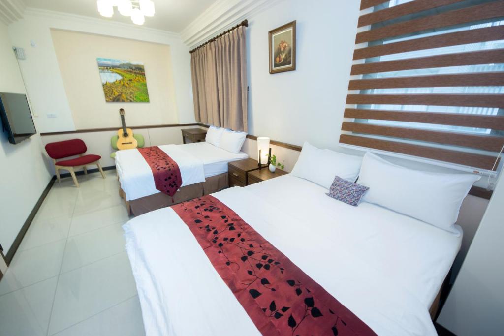 Postel nebo postele na pokoji v ubytování Guitar Charm B&B