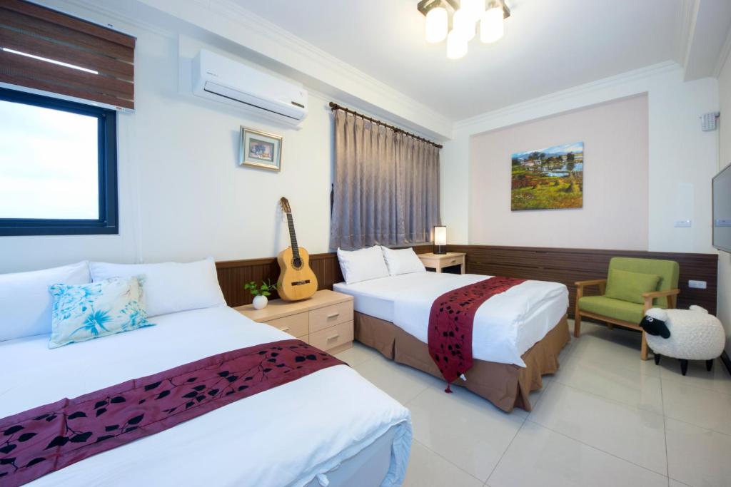 Postel nebo postele na pokoji v ubytování Guitar Charm B&B
