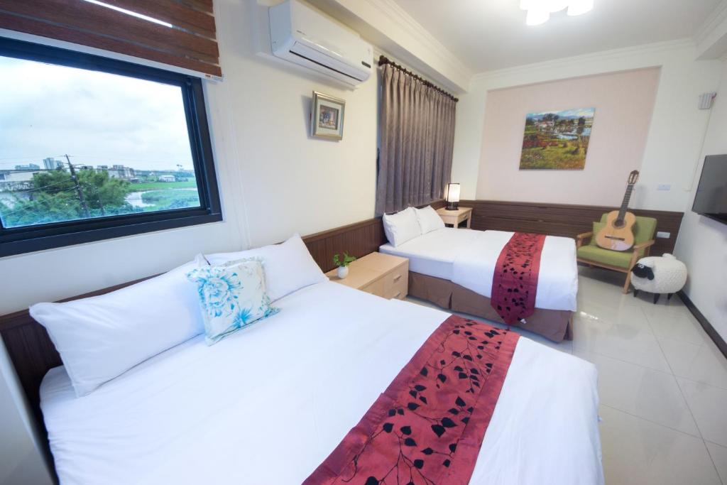 Postel nebo postele na pokoji v ubytování Guitar Charm B&B