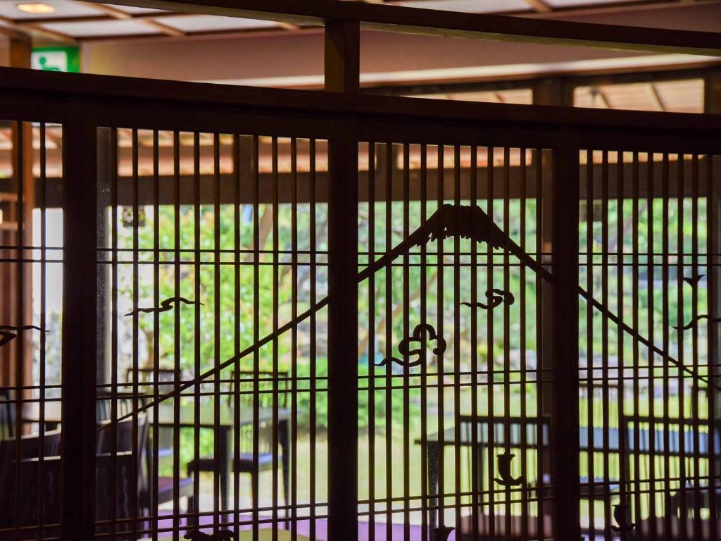 a bird cage with a chair in it at Hotel Hagoromo in Shizuoka
