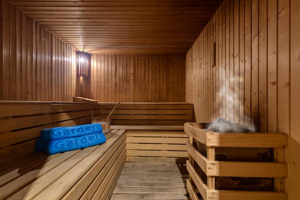 a wooden sauna with a blue container in it at Garden Playanatural - Adults Only in El Rompido