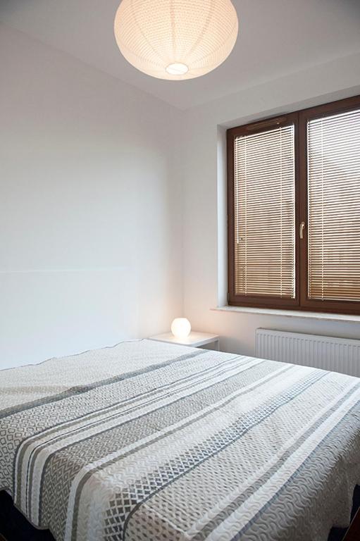Postel nebo postele na pokoji v ubytování DOMOTEL MOKOTÓW