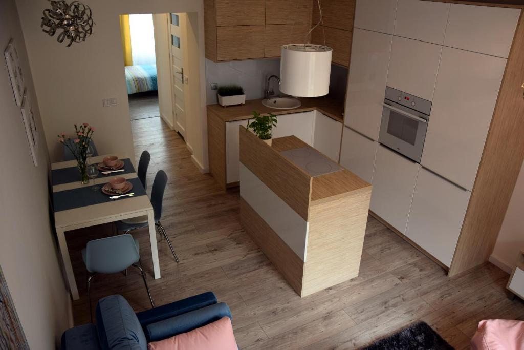 a small kitchen with a counter and a table at Apartament Zawiszy Czarnego 10 in Koszalin
