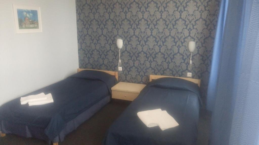 Postel nebo postele na pokoji v ubytování Alex Hotel