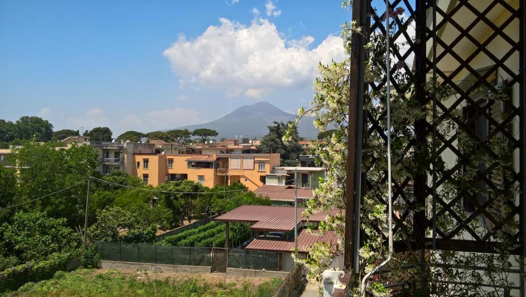 a view of a city with buildings and a mountain at B&B Lucius in Pompei