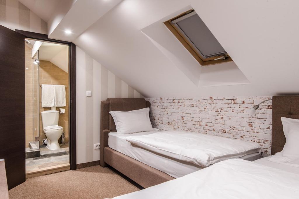 Postel nebo postele na pokoji v ubytování Centrum Sobe Rooms Čačak