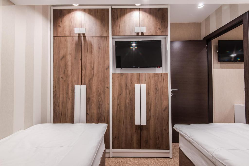 Postel nebo postele na pokoji v ubytování Centrum Sobe Rooms Čačak