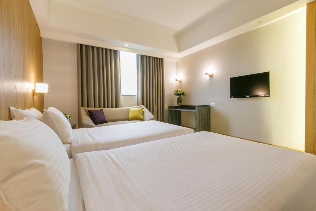מיטה או מיטות בחדר ב-Highness Hotel