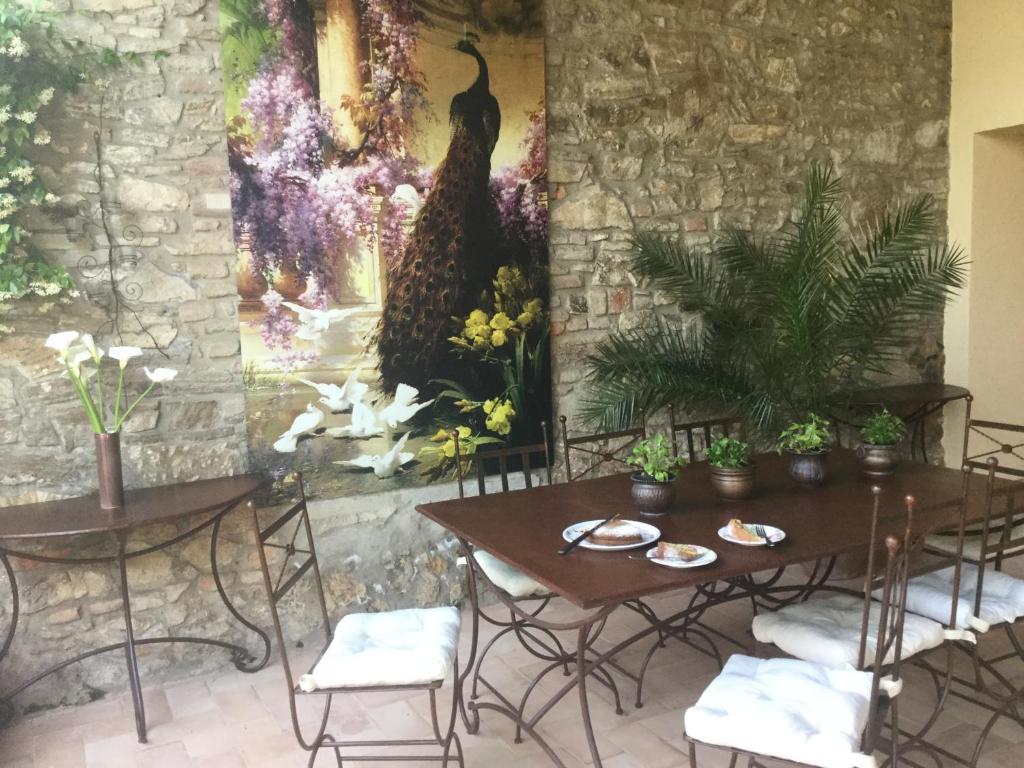 a restaurant with tables and chairs and a painting on the wall at Domus Rosarum in Arquà Petrarca