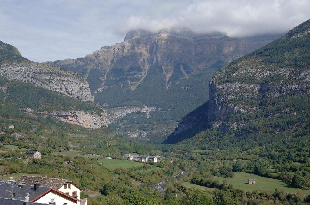a view of a mountain valley with houses and trees at Casa el Parque Cajal in Torla-Ordesa