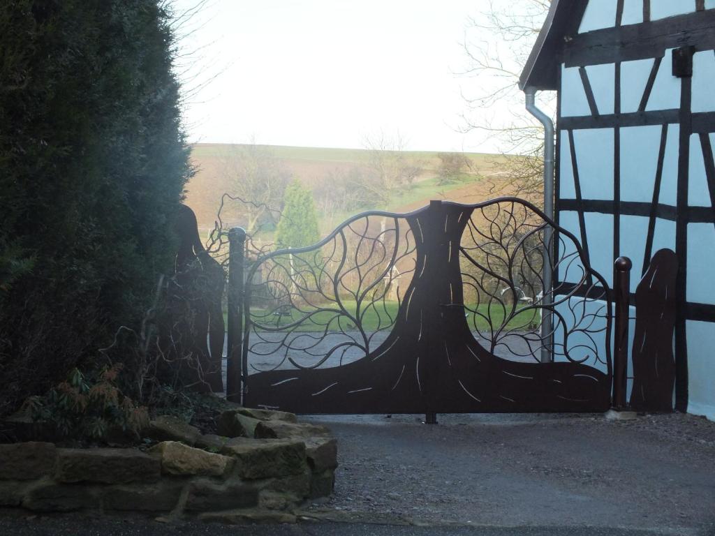a metal gate with a view of a body of water at Gîte Découverte Alsace in Kuhlendorf