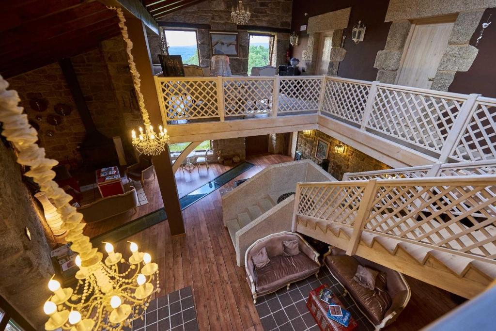 an overhead view of a living room with a staircase at A Aira da Petada Hotel Boutique in Corzos