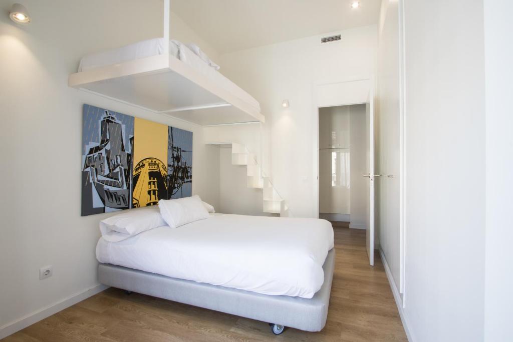 A bed or beds in a room at Valencia Luxury - Boutique Redonda