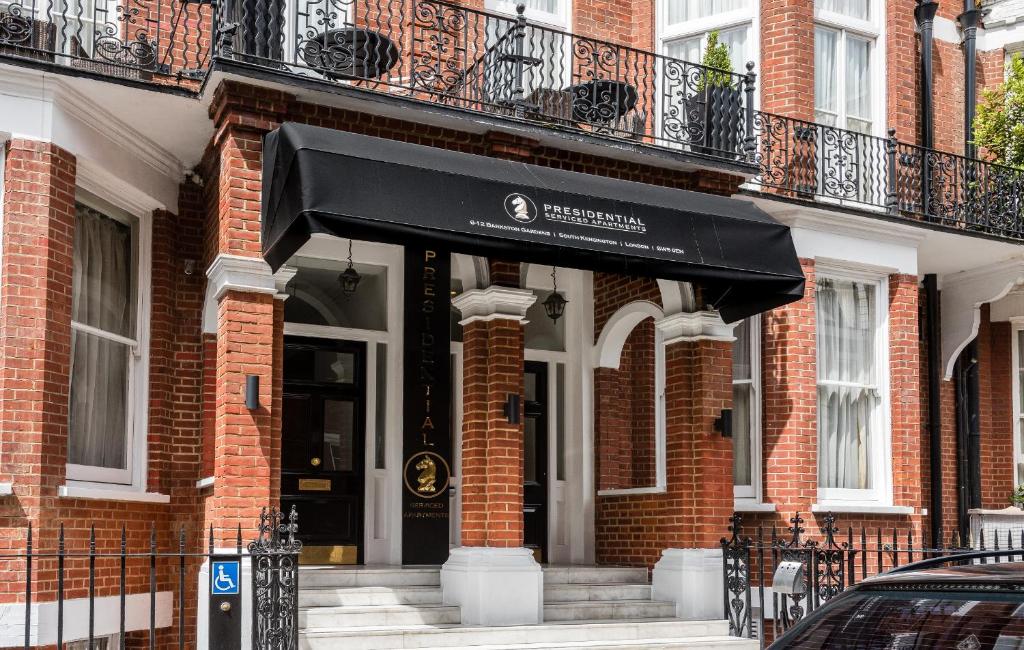 a building with a black an awning on it at Presidential Apartments Kensington in London