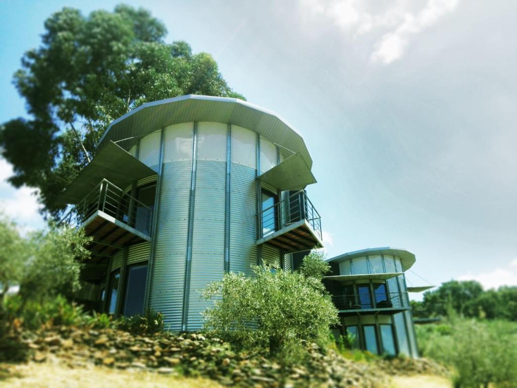 a building on top of a hill with trees at Bela Vista Silo Housing in Alfândega da Fé