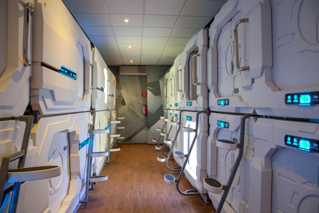 a row of white machines in a room at Izzzleep Aeropuerto Terminal 1 in Mexico City