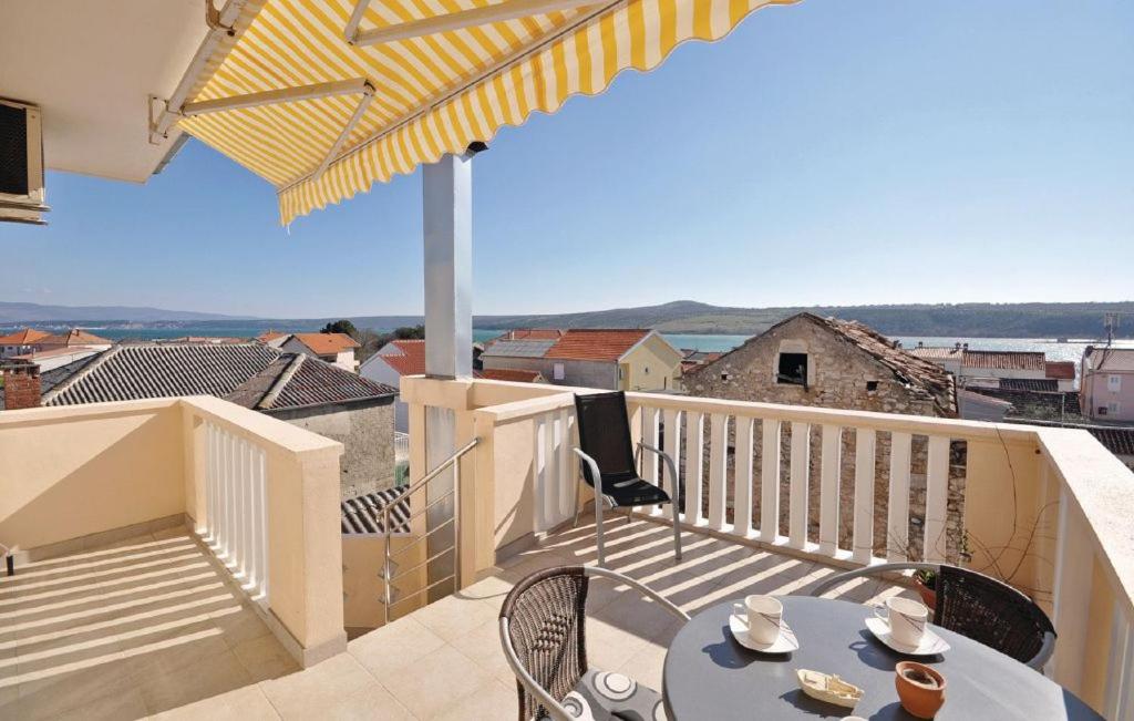 a balcony with a table and chairs on a balcony at Apartments Kontrada in Posedarje