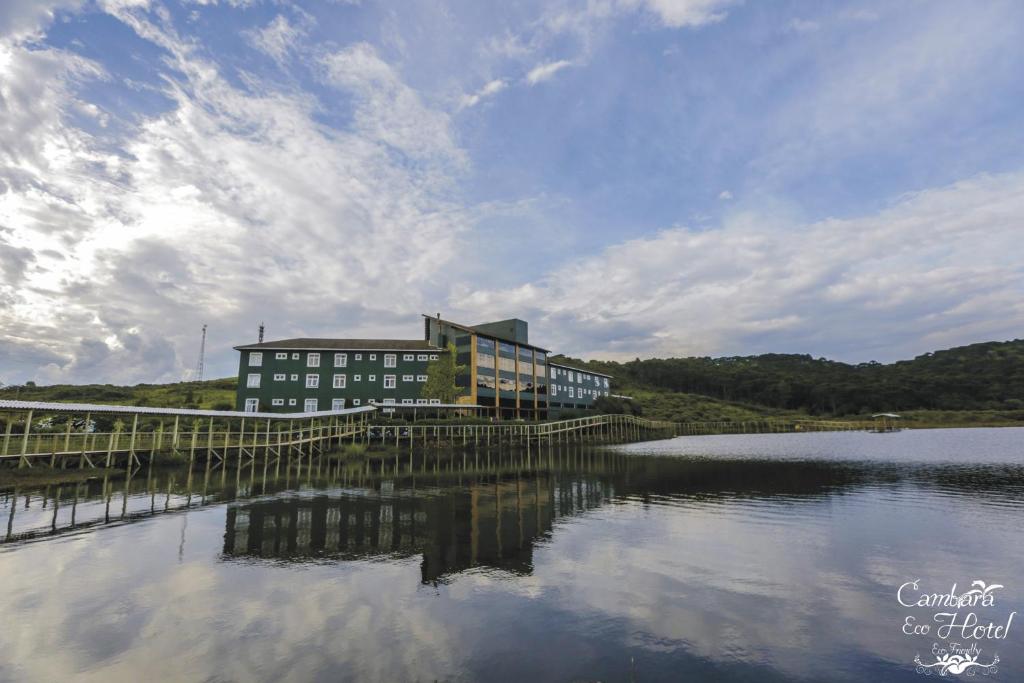 a building sitting next to a large body of water at Cambará Eco Hotel in Cambará