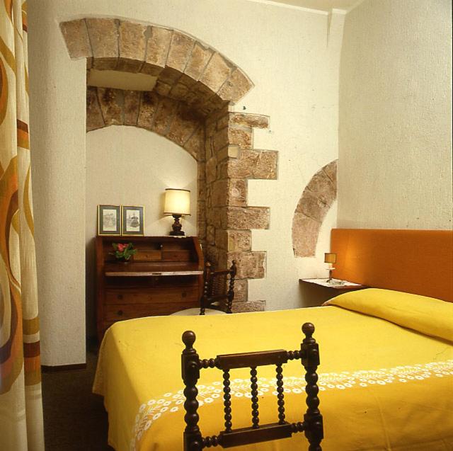 Postel nebo postele na pokoji v ubytování Hotel Umbra