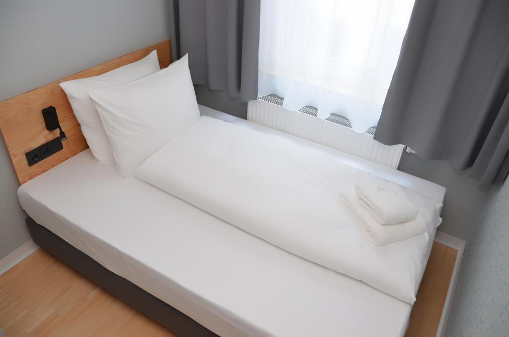 Postel nebo postele na pokoji v ubytování mk | hotel münchen city