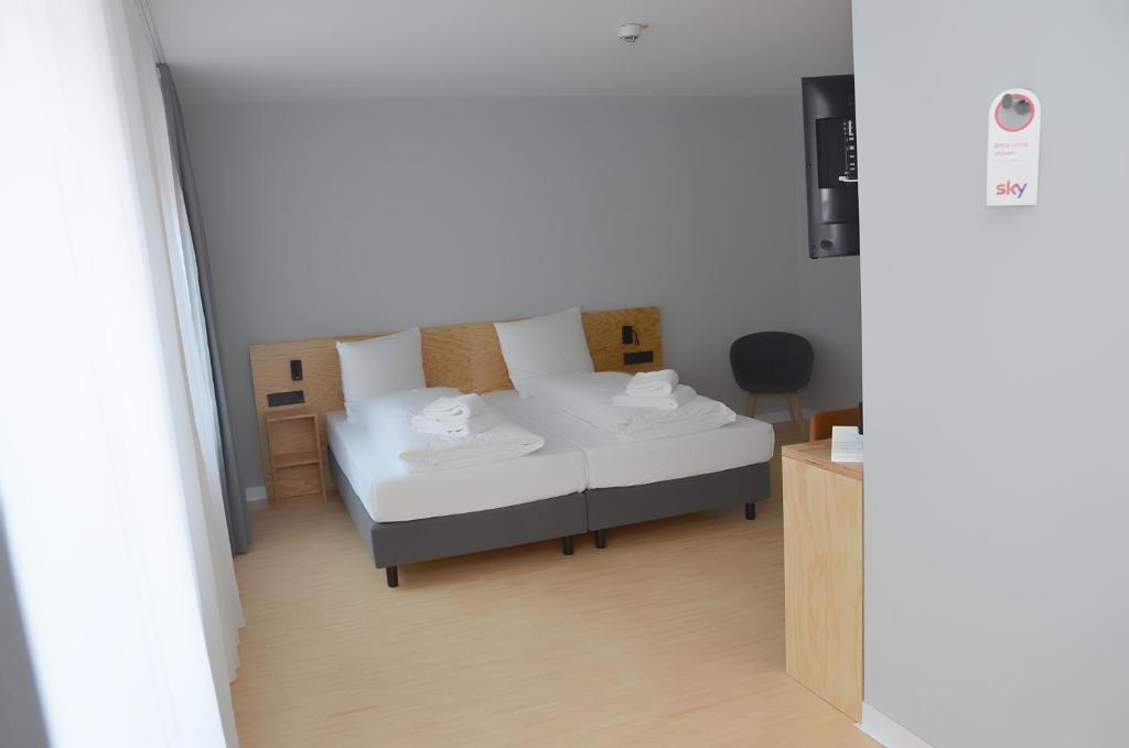 Postel nebo postele na pokoji v ubytování mk | hotel münchen city