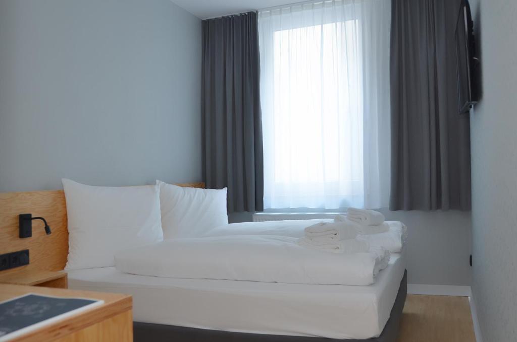 Postel nebo postele na pokoji v ubytování mk | hotel münchen city