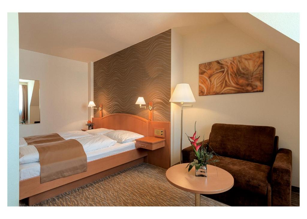 Postel nebo postele na pokoji v ubytování Club Hotel Cortina