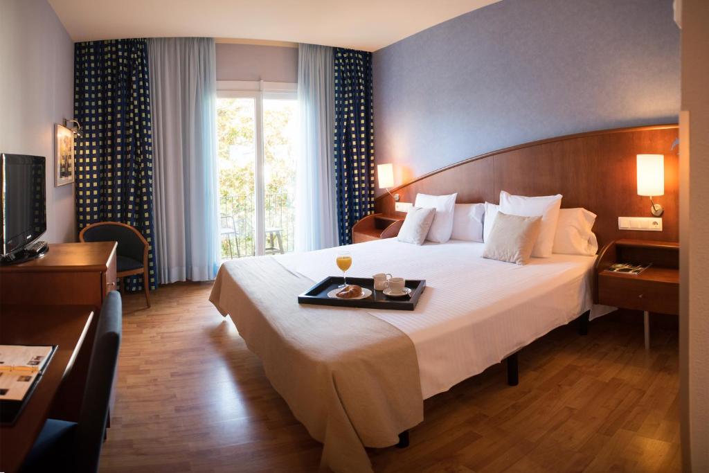 Postel nebo postele na pokoji v ubytování Hotel Delfín