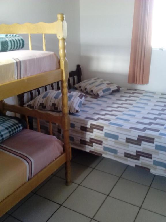 Postel nebo postele na pokoji v ubytování Hotel Pousada Guaratuba