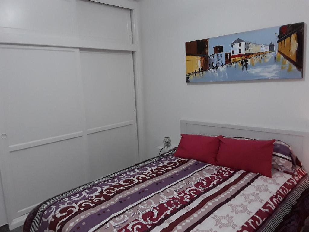 A bed or beds in a room at Central Seaview Apartment Puerto del Carmen