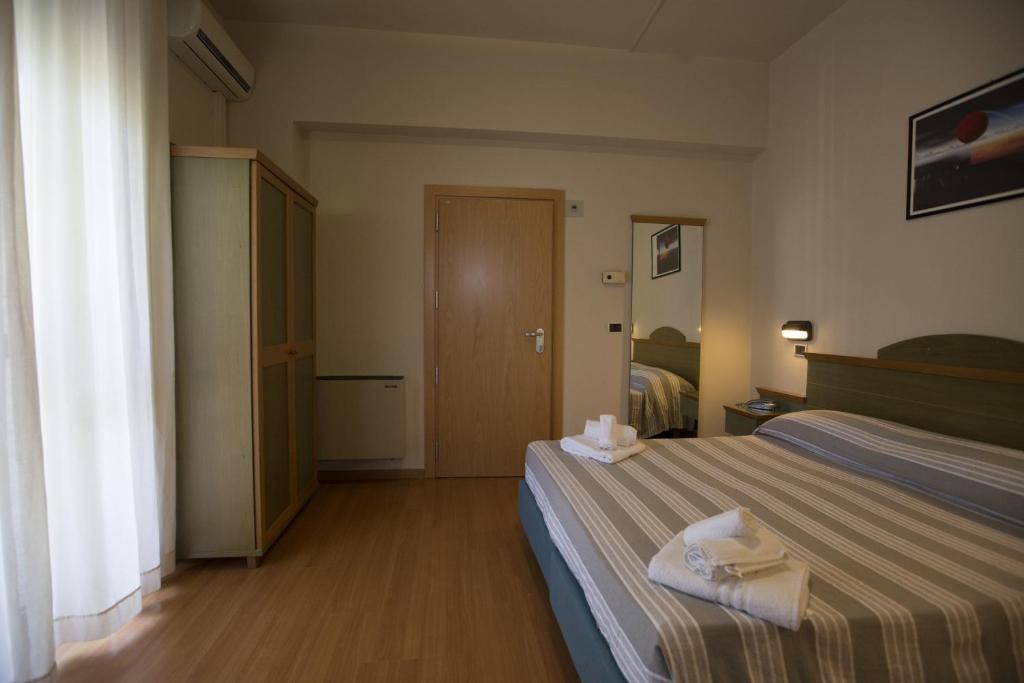 Postel nebo postele na pokoji v ubytování Hotel Impero