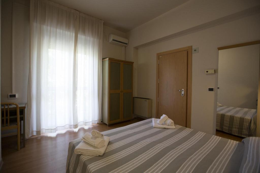 Postel nebo postele na pokoji v ubytování Hotel Impero