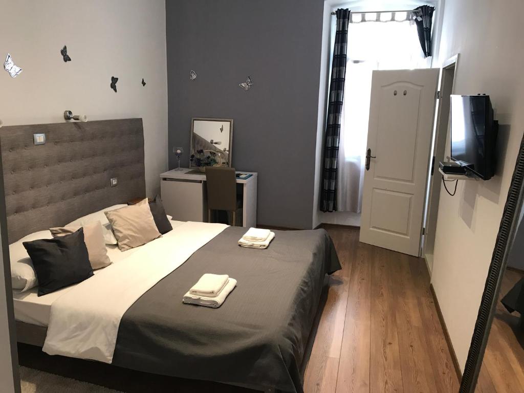 a bedroom with a bed with two towels on it at Pula Antic Rooms in Center in Pula