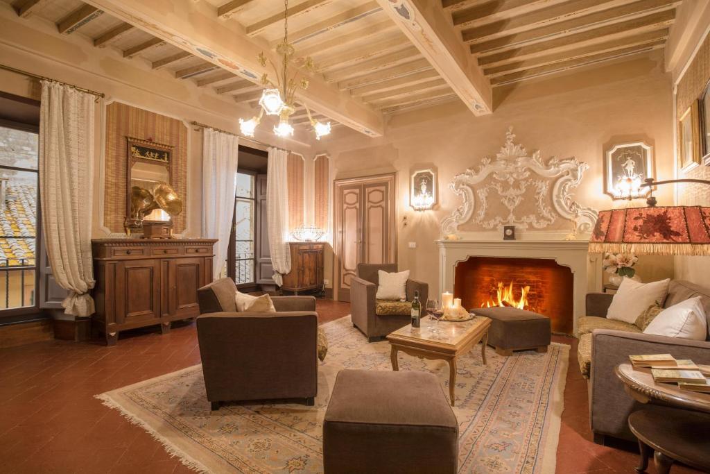 a living room filled with furniture and a fireplace at Residenza Fabroni in Montepulciano