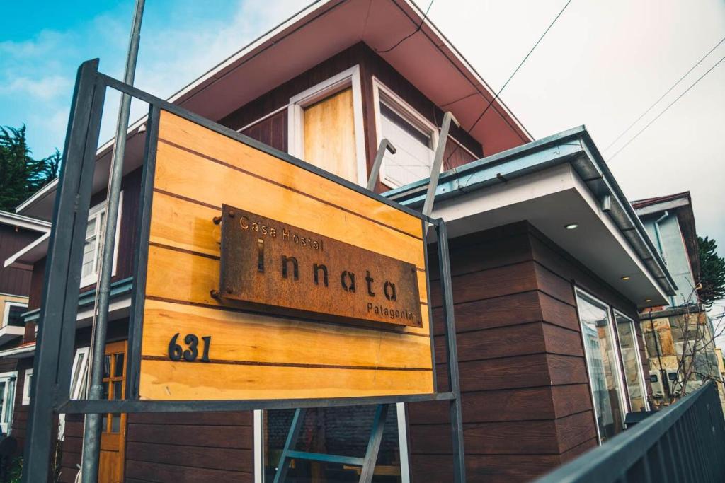 a house with a sign on the front of it at Innata Casa Hostal in Punta Arenas