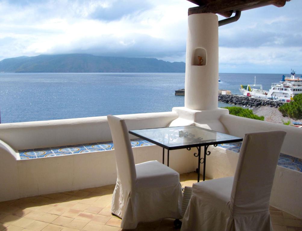 a dining room table with a view of the ocean at Hotel Santa Marina Antica Foresteria in Santa Marina Salina